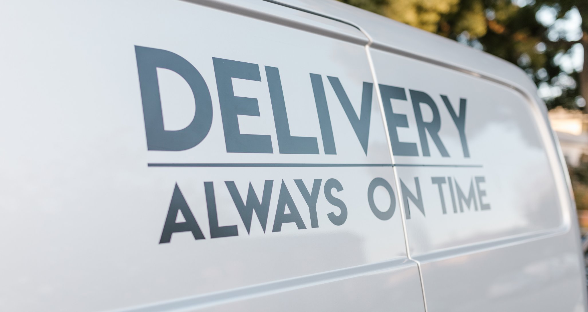 Close-up of a Precision Laundry Sales van reading Delivery, Always On Time